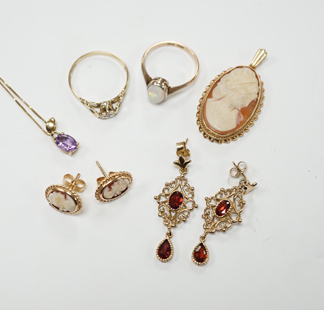 Two 9ct and gem set rings, including diamond chip and white opal, a 9ct and amethyst set pendant necklace, pair of 9ct gold and garnet earrings, a 9ct mounted cameo shell brooch and pair of matching earrings, gross weigh